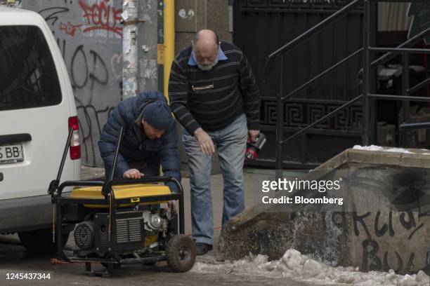 Residents start a generator in the street in Kyiv, Ukraine, on Tuesday, Dec. 6, 2022. Ukrainians have been no strangers to hardship over the past...