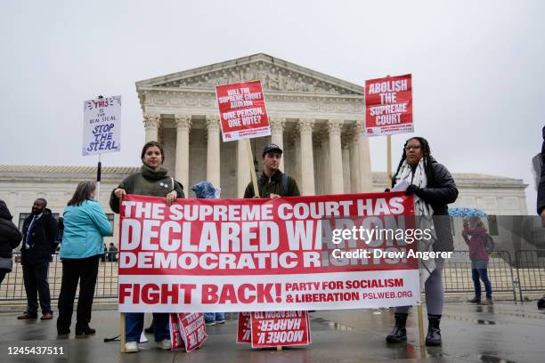 Demonstrators rally for voting rights outside the U.S. Supreme Court to hear oral arguments in the Moore v. Harper case on December 7, 2022 in...