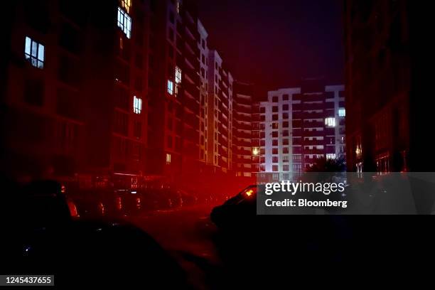 Apartments illuminated by personal power sources and car lights during a power outage in Kyiv, Ukraine, on Tuesday, Dec. 6, 2022. Ukrainians have...