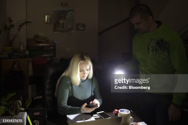 Household appliance service center operates with the use of torches during a power outage in Kyiv, Ukraine, on Tuesday, Dec. 6, 2022. Ukrainians have...
