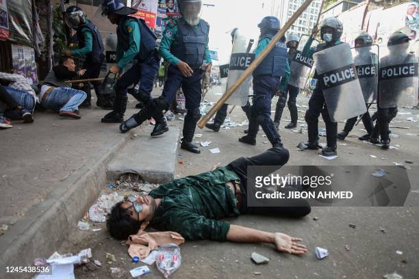 Police charge baton on Bangladesh Nationalist Party activities as they gathered in front of the party's central office in Dhaka on December 7 ahead...
