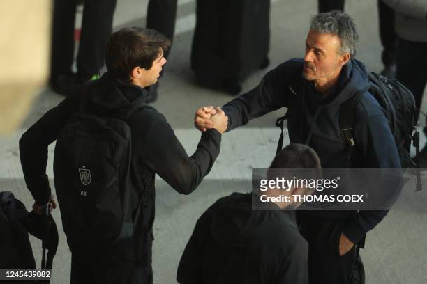 Spain's coach Luis Enrique shakes hands with assistant coach Aitor Unzue upon their arrival with some members of Spain team at the Adolfo Suarez...