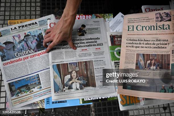 Vendor shows the front page of Argentine newspapers the day after Argentina's vice-president Cristina Fernandez de Kirchner was convicted on...