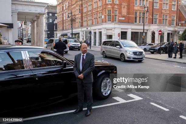 Rolls Royce car with driver stops to pick up a group of men in the exclusive area of Mayfair on 2nd December 2022 in London, United Kingdom....