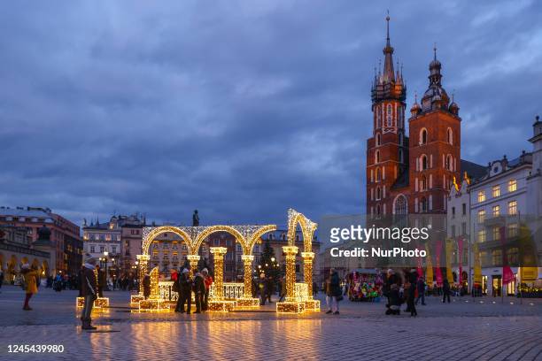 Christmas decorations and a view on St. Mary's Basilica at the Main Square of the Old Town in Krakow, Poland on December 7the, 2022.