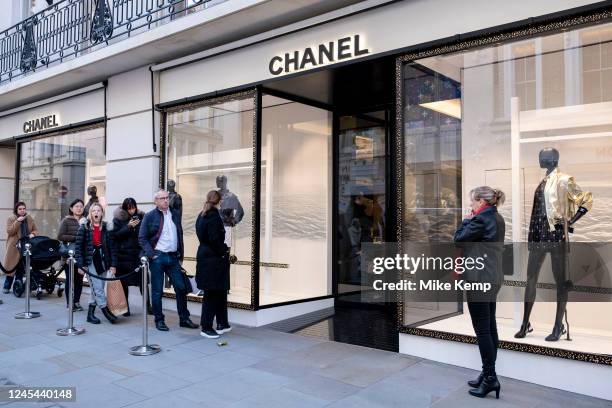 Queue outside Chanel on New Bond Street on 2nd December 2022 in London, United Kingdom. Bond Street is one of the principal streets in the West End...