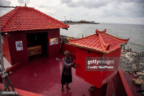 Mr. Carmat , cleans the Temple which he was mandated to protect from the threat of drowning due to wave abrasion and rising sea levels in Cemarajaya...