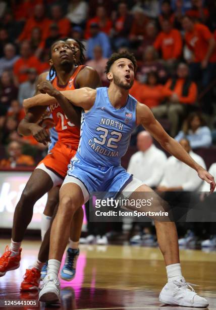 North Carolina Tar Heels forward Pete Nance attempts to box out Virginia Tech Hokies forward Justyn Mutts during a men's college basketball game...