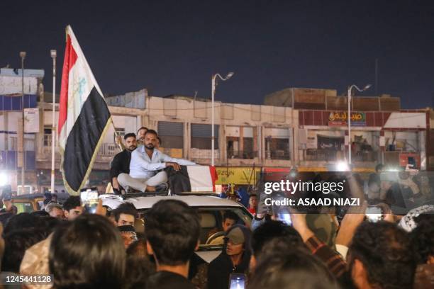 Mourners accompany the casket of one of the two protesters killed earlier in clashes with security forces, in the southern Iraqi city of Nasiriyah,...