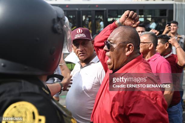 Supporters of Peruvian President Pedro Castillo protest outside the Lima Prefecture, where Castillo is alleged to be, in Lima, on December 7, 2022. -...