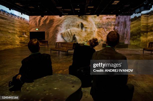 People visit the immersive video experience hosted by the National Geographic Society at a press event during the United Nations Biodiversity...