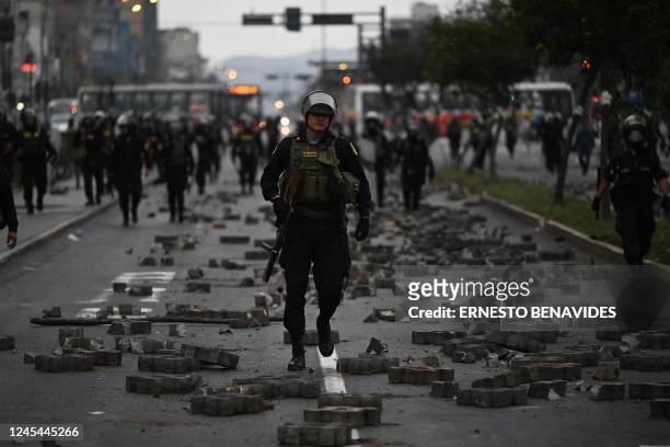 Members of the Police are seen during clashes with supporters of Peruvian former President Pedro Castillo in the outskirts of the Lima Prefecture,...