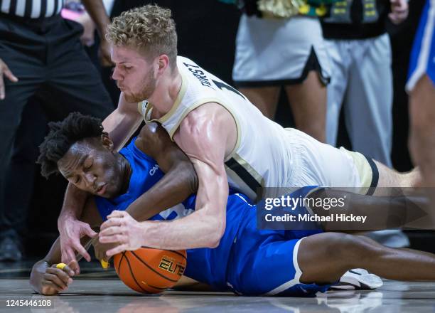 Tyler Thomas of the Hofstra Pride and Caleb Furst of the Purdue Boilermakers battle for the loose ball during the first half at Mackey Arena on...