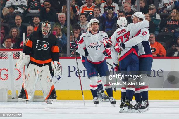 Oshie of the Washington Capitals celebrates with Dylan Strome and Matt Irwin after scoring a goal against the Philadelphia Flyers in the second...