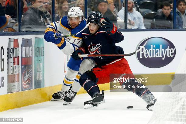 Tyson Jost of the Buffalo Sabres and Tim Berni of the Columbus Blue Jackets chase after the puck during the first period of the game at Nationwide...