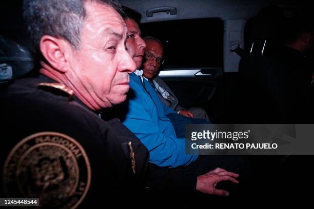Peru's former President Pedro Castillo is seen inside a police car as he leaves the Lima Prefecture, where he was under detention, in Lima, on...