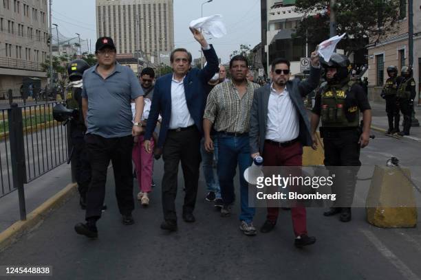 Jorge del Castillo, former congressman and mayor of Lima, center left, protests with demonstrators against Pedro Castillo, Peru's former president,...