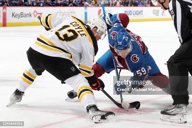 Charlie Coyle of the Boston Bruins faces off against Ben Meyers of the Colorado Avalanche at Ball Arena on December 7, 2022 in Denver, Colorado.
