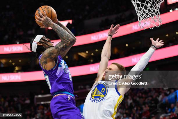 Jordan Clarkson of the Utah Jazz shoots over Donte DiVincenzo of the Golden State Warriors during the first half of the game at Vivint Arena on...