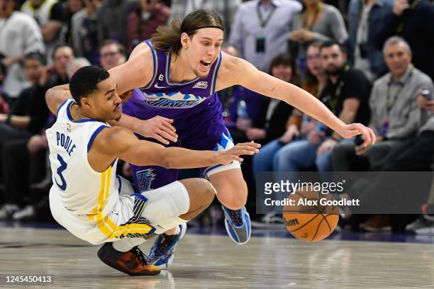 Kelly Olynyk of the Utah Jazz and Jordan Poole of the Golden State Warriors dive for the ball during the second half of the game at Vivint Arena on...