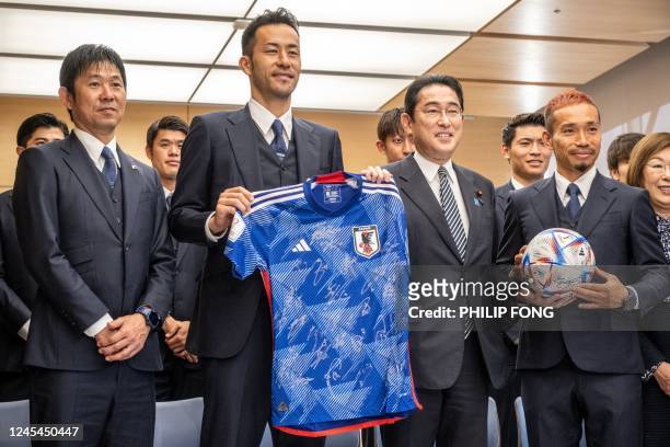 Japan's head coach Hajime Moriyasu , defender Maya Yoshida and defender Yuto Nagatomo pose with Japan's Prime Minister Fumio Kishida during a the...