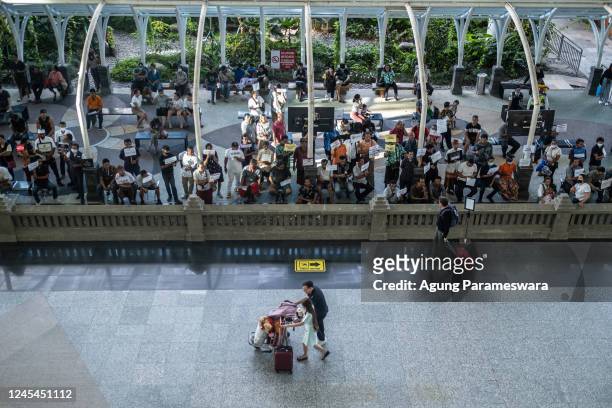 Foreign tourists push a trolly which contain of luggages as they arrive at the International arrival of Ngurah Rai airport on December 7, 2022 in...