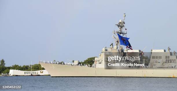 Navy destroyer Daniel Inouye sails through Pearl Harbor in Honolulu during a ceremony to commemorate the 81st anniversary of the attack on Dec. 7,...