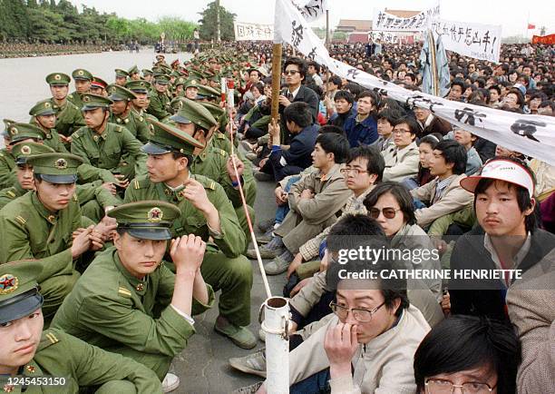 Picture dated 22 April 1989 shows several hundred of 200,000 pro-democracy student protesters face to face with policemen outside the Great Hall of...