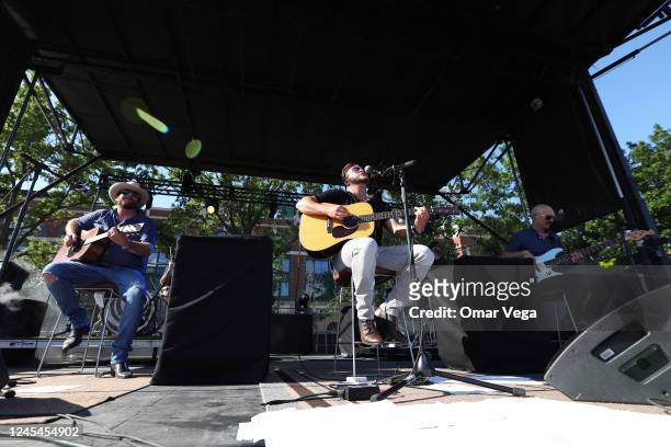 Guitarist James Young, singer Mike Eli and Jon Jones of Eli Young Band perform on stage during a concert at the Global Life Field parking lot on June...