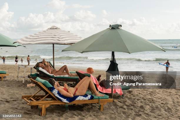 Tourists enjoy the popular surf beach at Batu Bolong on December 8, 2022 in Canggu, Bali, Indonesia. Indonesia's parliament voted to pass a law that...