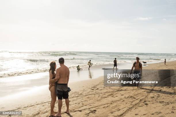 Tourists enjoy the popular surf beach at Batu Bolong on December 8, 2022 in Canggu, Bali, Indonesia. Indonesia's parliament voted to pass a law that...