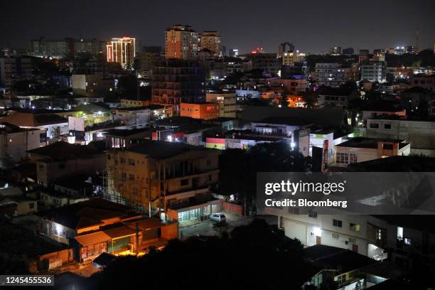 Residential and commercial buildings on the skyline at night in Accra, Ghana, on Sunday, Dec. 4, 2022. With debt interest payments eating up more...