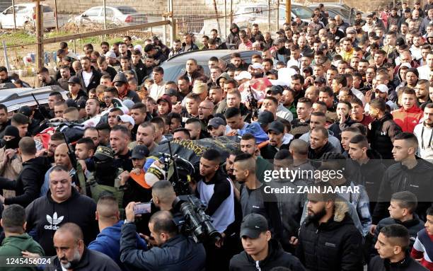 Graphic content / Palestinian mourners carry the bodies of three Palestinians killed by Israeli forces in a raid in the West Bank city of Jenin,...