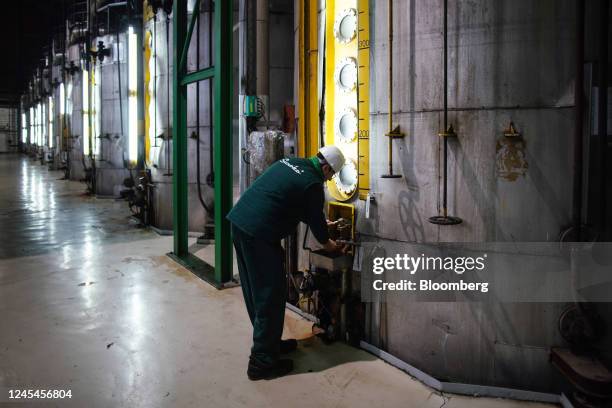 An employee checks the molasses desugarization process in a vat at the Sunoko sugar plant, operated by MK Group, in Pecinci, Serbia, on Wednesday,...