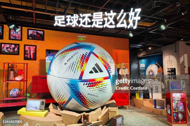 The official World Cup match ball AL RIHLA and a giant soccer model are displayed inside an Adidas store in Shanghai, China, December 8, 2022.