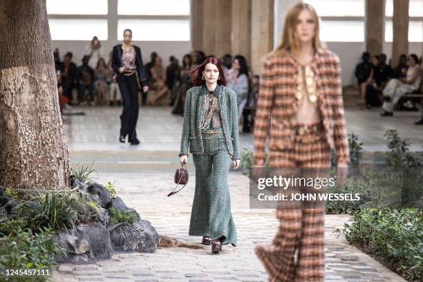 Models walk down the catwalk during the luxury brand Chanels fashion show, Metiers dart, in Dakar on December 06, 2022. - For the first time ever...