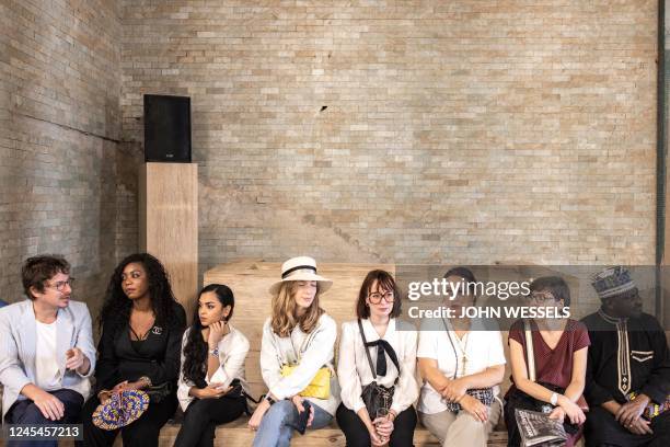 Invitees look on during the luxury brand Chanels fashion show, Metiers dart, in Dakar on December 06, 2022. - For the first time ever luxury brand...