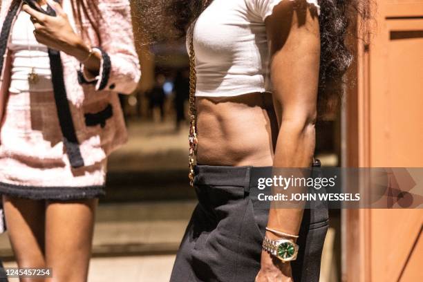 Women leave the venue after the luxury brand Chanels fashion show, Metiers dart, in Dakar on December 06, 2022. - For the first time ever luxury...