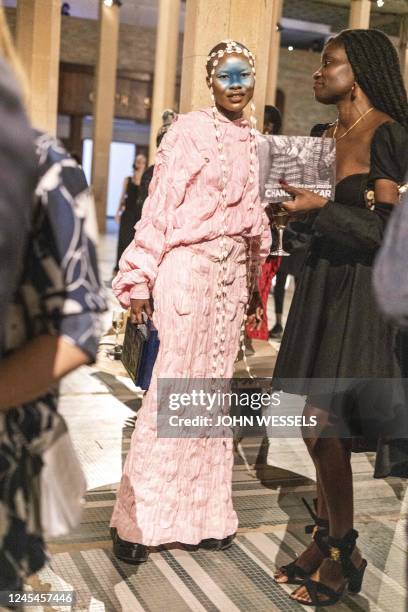 Ivorian artist and designer Lafalaise Dion looks on during the luxury brand Chanels fashion show, Metiers dart, in Dakar on December 06, 2022. - For...