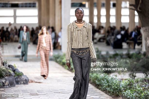 Model walks down the catwalk during the luxury brand Chanels fashion show, Metiers dart, in Dakar on December 06, 2022. - For the first time ever...