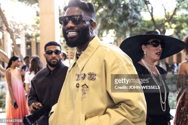 Rapper Tobe Nwigwe smiles during the luxury brand Chanels fashion show, Metiers dart, in Dakar on December 06, 2022. - For the first time ever luxury...