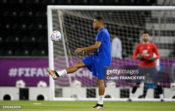 France's forward Kylian Mbappe controls the ball during a training session at the Al Sadd SC training center in Doha, on December 8 in the build-up...