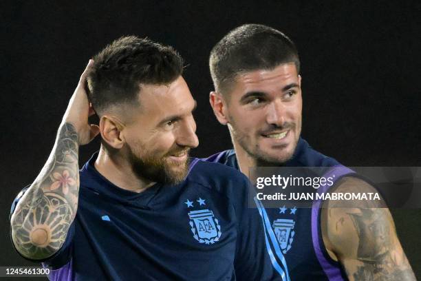 Argentina's forward Lionel Messi and Argentina's midfielder Rodrigo De Paul take part in a training session at Qatar University in Doha on December 8...