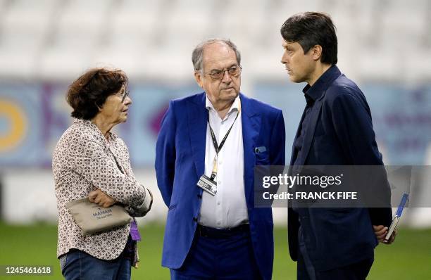 French Football Federation President Noel Le Graet and his wife speak with France Press officer Raphael Raymond before a training session at the Al...