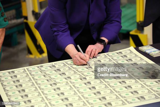 Janet Yellen, US Treasury secretary, signs banknotes at the Bureau of Engraving and Printing's Western Currency Facility in Fort Worth, Texas, US, on...