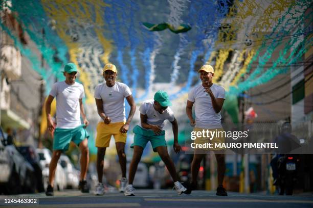 Funk music group Os Quebradeiras dance on a street decorated for the Qatar 2022 World Cup at Tijuca neighborhood, in Rio de Janeiro, Brazil, on...