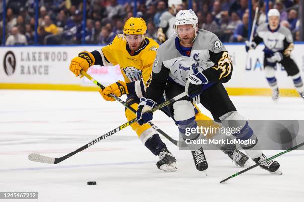 Steven Stamkos of the Tampa Bay Lightning skates against Yakov Trenin of the Nashville Predators during the first period at Amalie Arena on December...