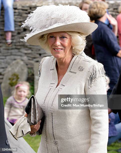 Camilla, Duchess of Cornwall attends the wedding of her nephew Ben Elliot and Mary-Clare Winwood at the church of St. Peter and St. Paul, Northleach...