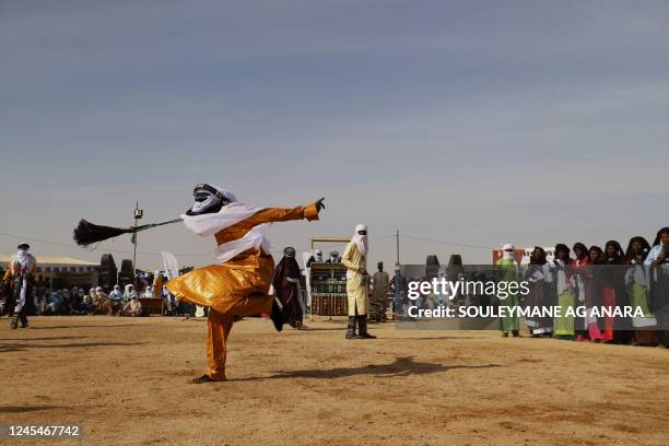 Tuareg dancer performs to the rytme of the tende, drum made out of a mortar, in Iferouane on December 4, 2022 during the Festival de l'Aïr, a...