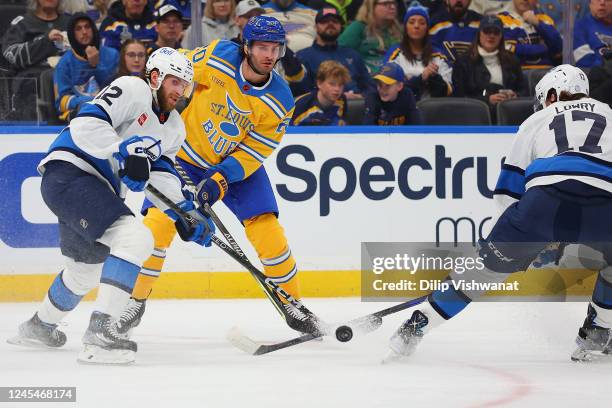 Brandon Saad of the St. Louis Blues looses the puck against Jansen Harkins of the Winnipeg Jets in the first period at Enterprise Center on December...